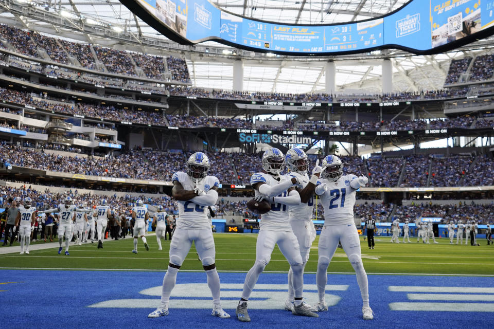 Detroit Lions safety Kerby Joseph (31) second from left, celebrates with teammates in the end zone after intercepting a pass during the first half an NFL football game against the Los Angeles Chargers Sunday, Nov. 12, 2023, in Inglewood, Calif. (AP Photo/Ashley Landis)