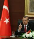 Turkish Prime Minister Recep Tayyip Erdogan speaks to the media in his office in Ankara, Turkey, Wednesday, April 23, 2014. Erdogan has issued a conciliatory message to Armenians on the eve of the anniversary of the massacre of Armenians almost a century ago, calling the events of World War I "our shared pain." In a statement released Wednesday in nine languages including Armenian Erdogan said he hoped Armenians who lost their lives are in peace and expressed condolences to their descendants.(AP Photo)