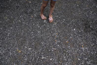 Avery Moore, 4, of Athens, Ala., waits for her grandfather to come outside on Thursday, June 23, 2022, in Athens, Ala. "Where is Uncle David again, is he coming home soon," says Avery. Her mother says she is still confused about where her uncle is and why he hasn't come back home. David Guess' killing drew little attention outside the rural stretch of northern Alabama where Guess grew up, though his death shattered many lives. (AP Photo/Brynn Anderson)