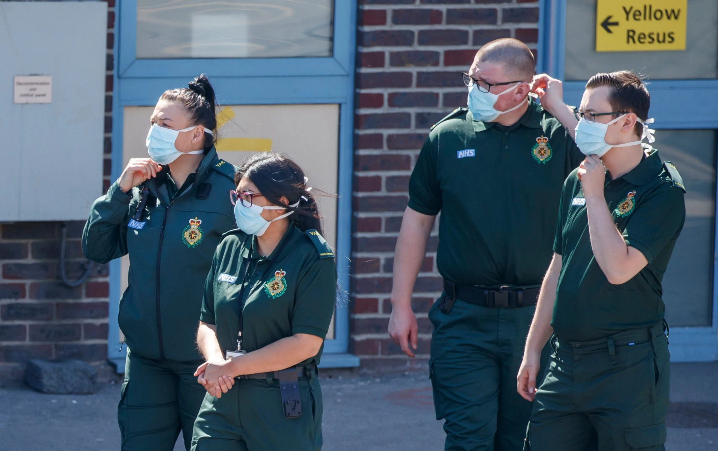 Ambulance crew members wear face masks outside Doncaster Royal Infirmary