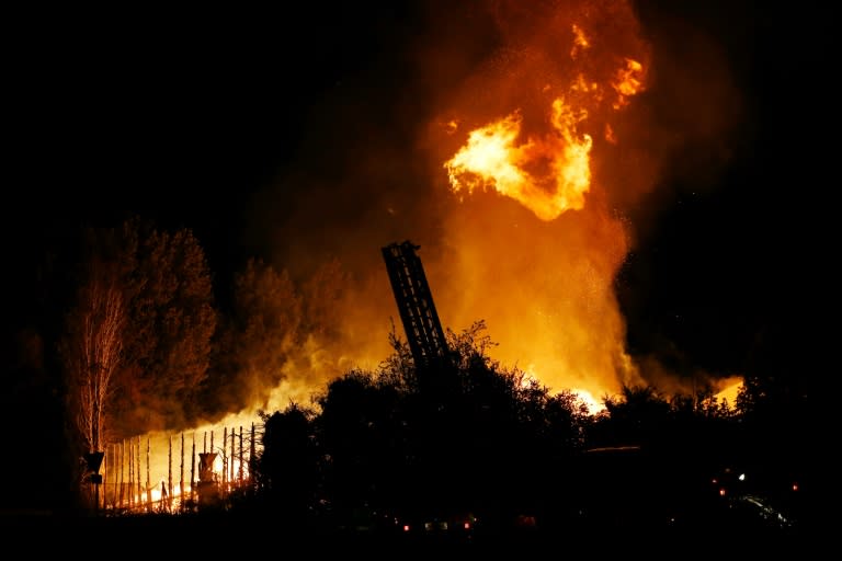 A warehouse burns in Persan, near Beaumont-sur-Oise, on July 23, 2016, following clashes between residents and police over the death of Adama Traore