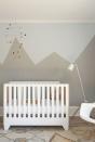 <p>Just because it's a nursery doesn't mean it needs to be super whimsical and soft. <a href="https://www.studiodb.com/" rel="nofollow noopener" target="_blank" data-ylk="slk:Studio DB;elm:context_link;itc:0;sec:content-canvas" class="link ">Studio DB</a> chose a more angular approach with a graphic wall mural and modern geometric mobile. The colorful details and layers of shapes make it appropriately playful for a nursery.</p>