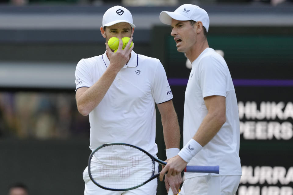 Andy, right, and Jamie Murray talk during their first round doubles match against Australia's John Peers and Ricky Hijikata at the Wimbledon tennis championships in London, Thursday, July 4, 2024. (AP Photo/Kirsty Wigglesworth)