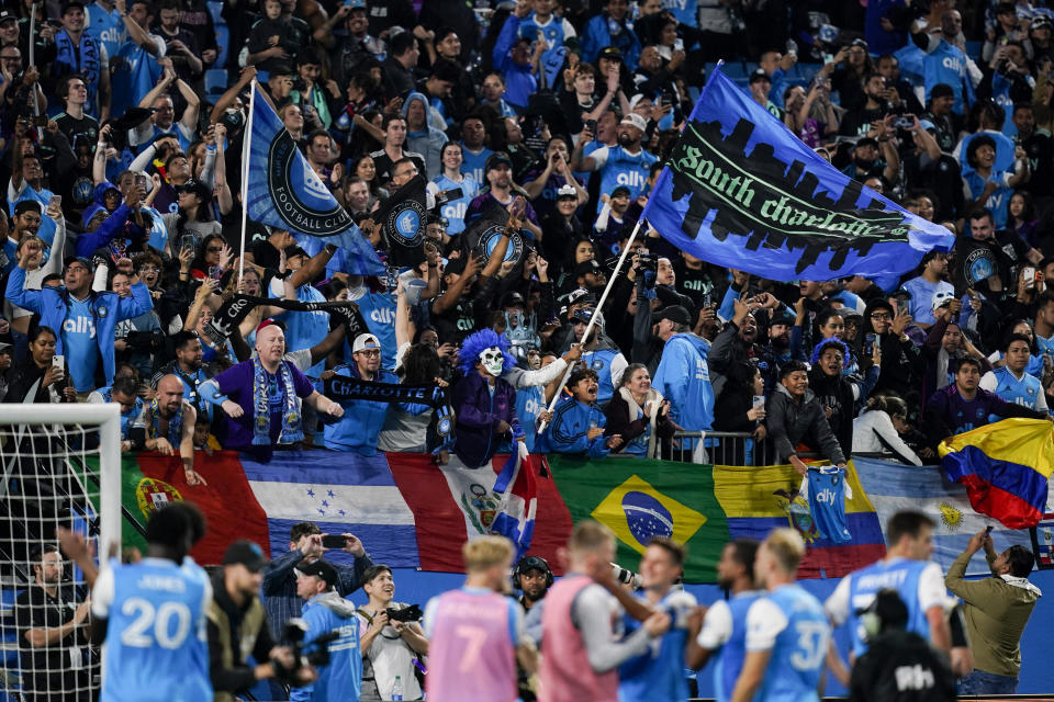 Fans celebrate after a win by Charlotte FC in an MLS soccer match against Inter Miami, Saturday, Oct. 21, 2023, in Charlotte, N.C. (AP Photo/Erik Verduzco)