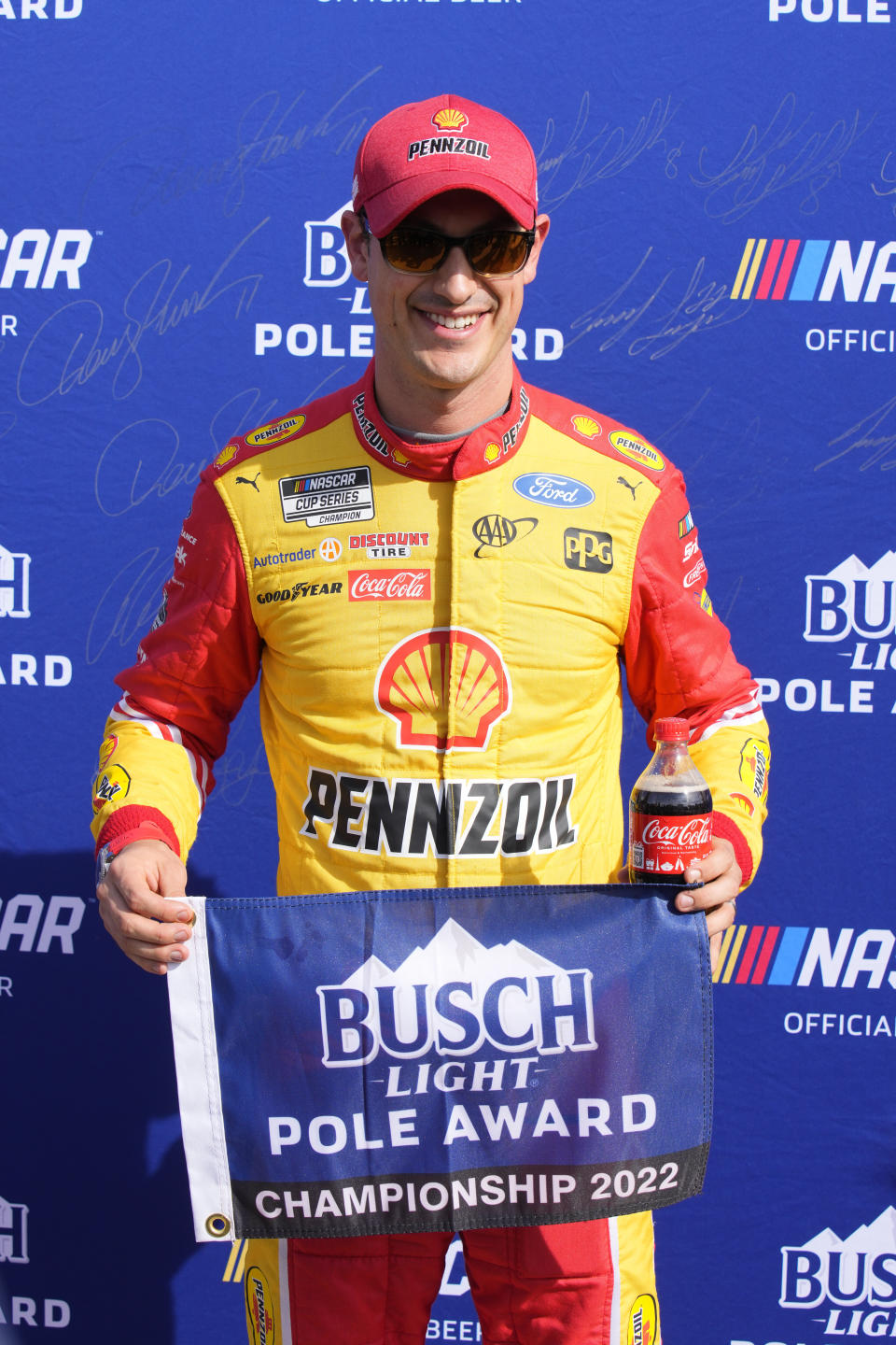 Joey Logano poses for the media after winning the pole for a NASCAR Cup Series auto race Saturday, Nov. 5, 2022, in Avondale, Ariz. The race is for the championship on Sunday. (AP Photo/Rick Scuteri)