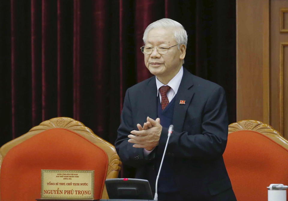 Vietnam Communist party General Secretary Nguyen Phu Trong applauds during a party meeting in Hanoi, Vietnam, Sunday, Jan. 31, 2021. Vietnam Communist Party has re-elected Nguyen Phu Trong for another term as the party's General Secretary, the country de-facto top leader. (Le Tri Dung/VNA via AP)