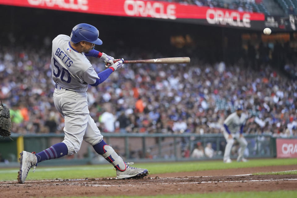 Los Angeles Dodgers' Mookie Betts hits a double against the San Francisco Giants during the third inning of a baseball game in San Francisco, Monday, Aug. 1, 2022. (AP Photo/Jeff Chiu)
