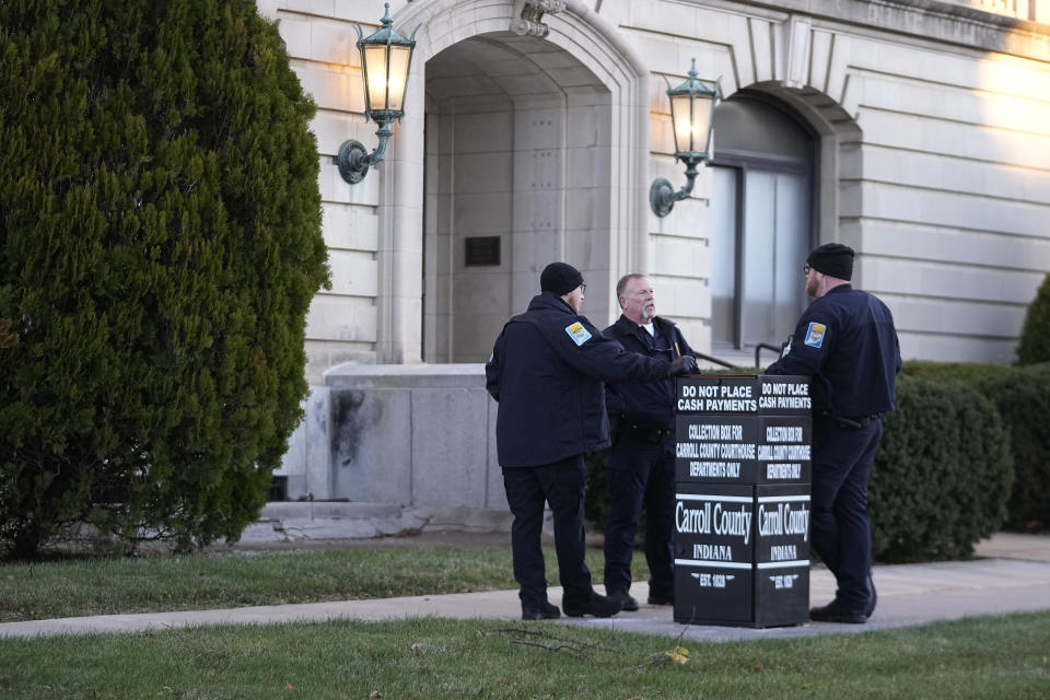 Officers stand outside of the Carroll County Courthouse, Tuesday, Nov. 22, 2022, in Delphi, Ind. An Indiana judge will hear if sealed court documents with evidence that led to a man's arrest in the 2017 slayings of two teenage girls will be publicly released. Richard Matthew Allen, a 50-year-old of Delphi, Indiana, was charged last month with two counts of murder in the killings of Liberty German, 14, and Abigail Williams, 13. (AP Photo/Darron Cummings)