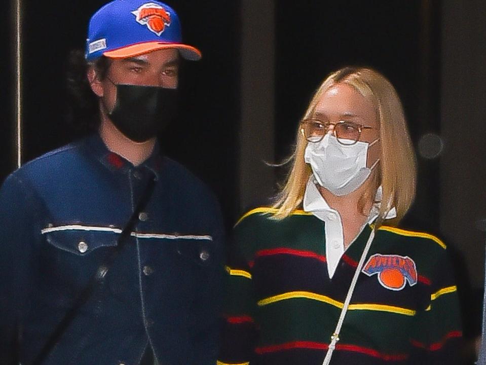 Sinisa Mackovic and Chloe Sevigny wearing face masks as they leave Madison Square Garden.