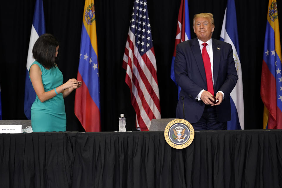 President Donald Trump and Rosa Maria Paya leave after a roundtable on Venezuela at Iglesia Doral Jesus Worship Center, Friday, July 10, 2020, in Doral, Fla. (AP Photo/Evan Vucci)