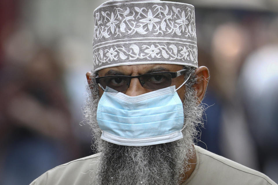 A man wears a face mask while walking downtown Sarajevo, Bosnia, Wednesday, Sept. 29, 2021. Public mistrust of authorities in corruption-plagued Bosnia has created an opening for anti-vaccination movement even though the Balkan nation has the highest rate in Europe of coronavirus deaths and faces a growing number of new infections. So far, despite an abundance of coronavirus vaccines in Bosnia, just under 13 percent of its 3.3 million people had been fully immunized against Covid-19. (AP Photo)