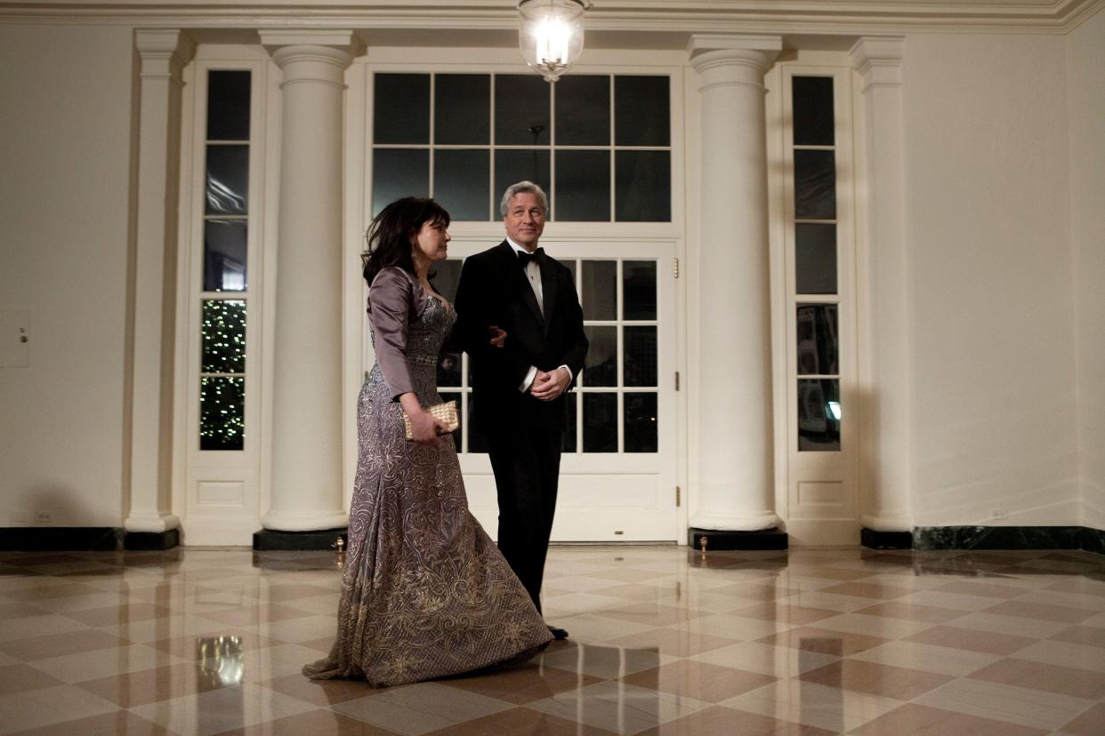Jamie Dimon and his wife, Judith, walk across the White House's marble floor, dressed in black tie event attire.