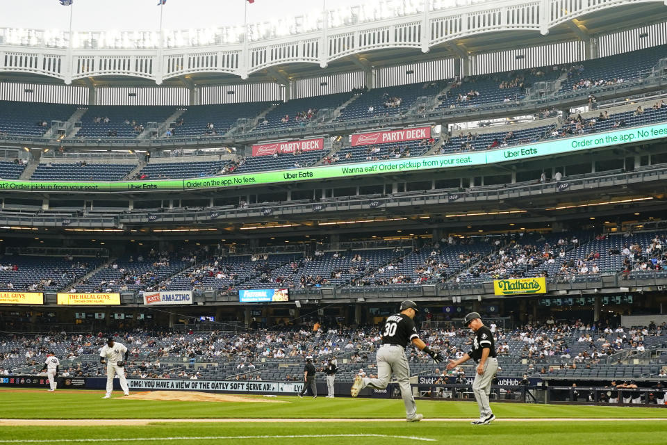 Chicago White Sox's Jake Burger (30) celebrates with third base coach Eddie Rodriguez as he runs the bases after hitting a two-run home run during the second inning in the first baseball game of a doubleheader against the New York Yankees Thursday, June 8, 2023, in New York. (AP Photo/Frank Franklin II)