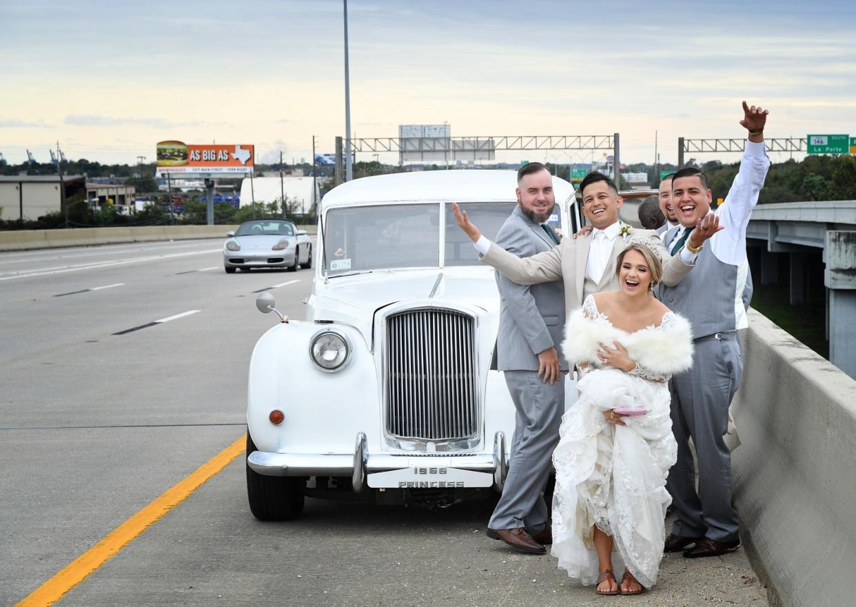 When the bride and groom’s vintage ride broke down on the freeway, the couple didn’t let it rain on their wedding day parade. (Photo: Courtesy of Tomas Romas)