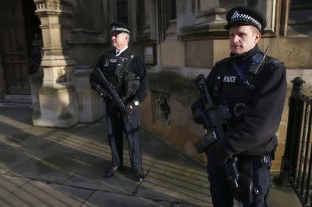 Armed police officers stand on duty outside the Houses of Parliament in Westminster, central London November 24, 2014. REUTERS/Andrew Winning