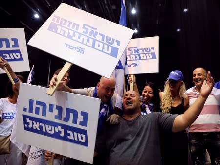 Supporters react at the Likud party headquarters following the announcement of exit polls during Israel's parliamentary election in Tel Aviv