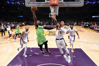 Minnesota Timberwolves' Josh Okogie (20) goes to basket under pressure from Los Angeles Lakers' Danny Green (14) during the first half of an NBA basketball game, Sunday, Dec. 8, 2019, in Los Angeles. (AP Photo/Ringo H.W. Chiu)