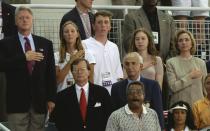<p>The Clinton family stands during the playing of the national anthem before the women's 4×200 meter freestyle relay at the Georgia Dome. (Getty) </p>