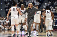 UConn's Paige Bueckers, center, reacts after UConn's Lou Lopez-Senechal, left, hit a 3 points basket at the end of the first quarter in the first half of an NCAA college basketball game against South Carolina, Sunday, Feb. 5, 2023, in Hartford, Conn. (AP Photo/Jessica Hill)