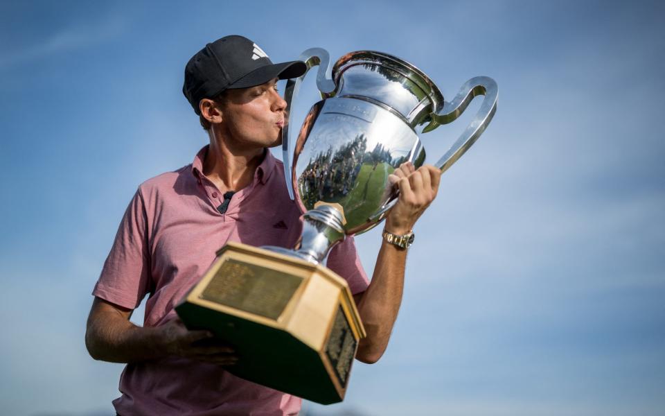 Sweden's Ludvig Aberg kisses the trophy after winning the European Tour's