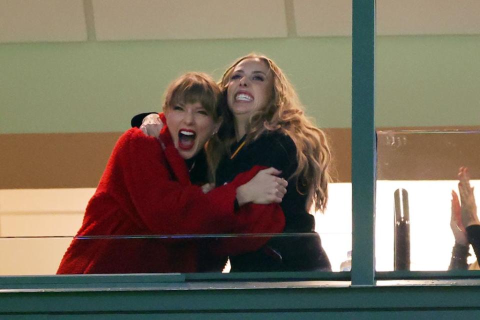 Taylor Swift and Brittany Mahomes hug during a football game