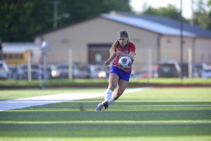 St. Clair's Ella Farkas strikes the ball toward midfield during the Saints' 2-0 win over St. Clair Shores Lake Shore in a district final at East China Stadium on Thursday, June 2, 2022.
