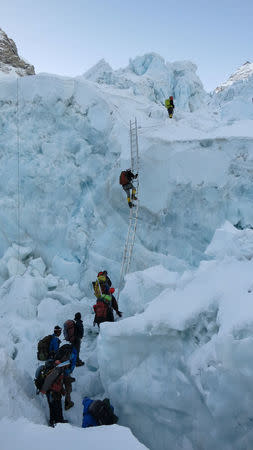 Climbers climb Khumbu Icefall using a ladder at Everest May 15, 2016. Phurba Tenjing Sherpa/Handout via REUTERS