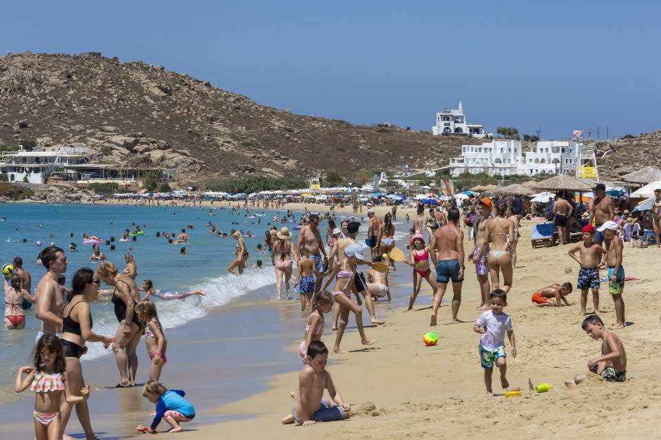 Crowds of tourists by the beach in Naxos, Greece