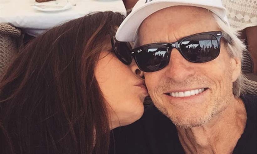 Catherine Zeta Jones gives Michael Douglas a joint birthday kiss