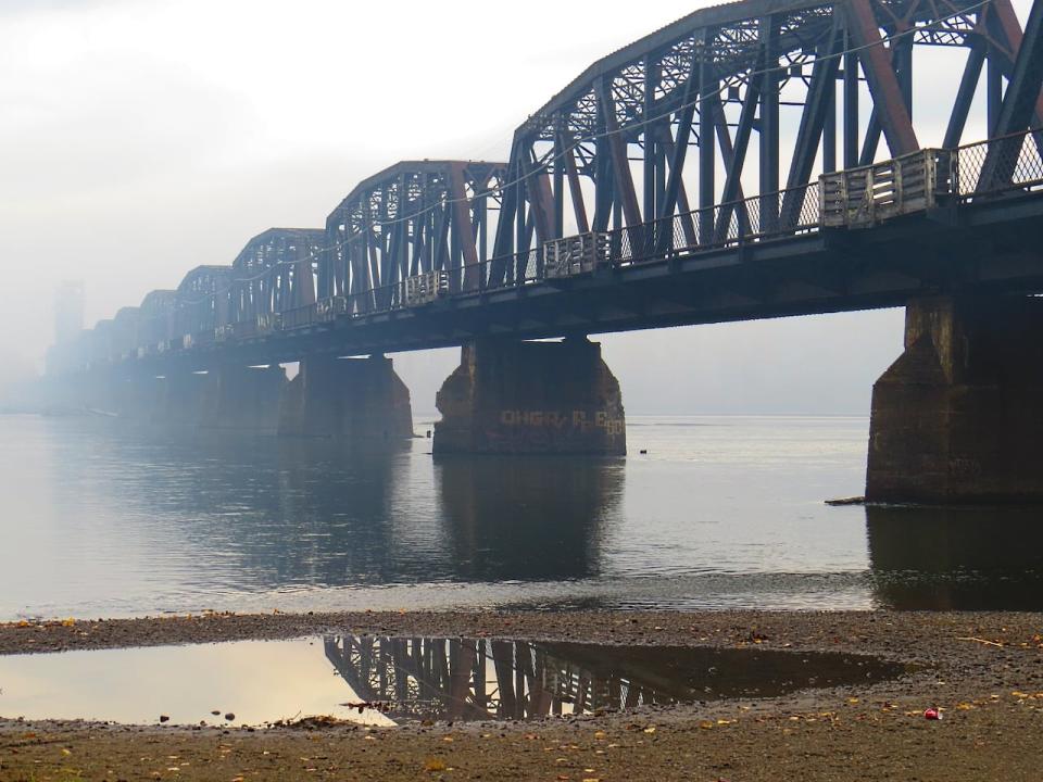 A Prince George, B.C., railway bridge at the confluence of the Nechako and Fraser rivers is seen in an October 2021 photograph. This October’s river levels are far below average for this time of year.