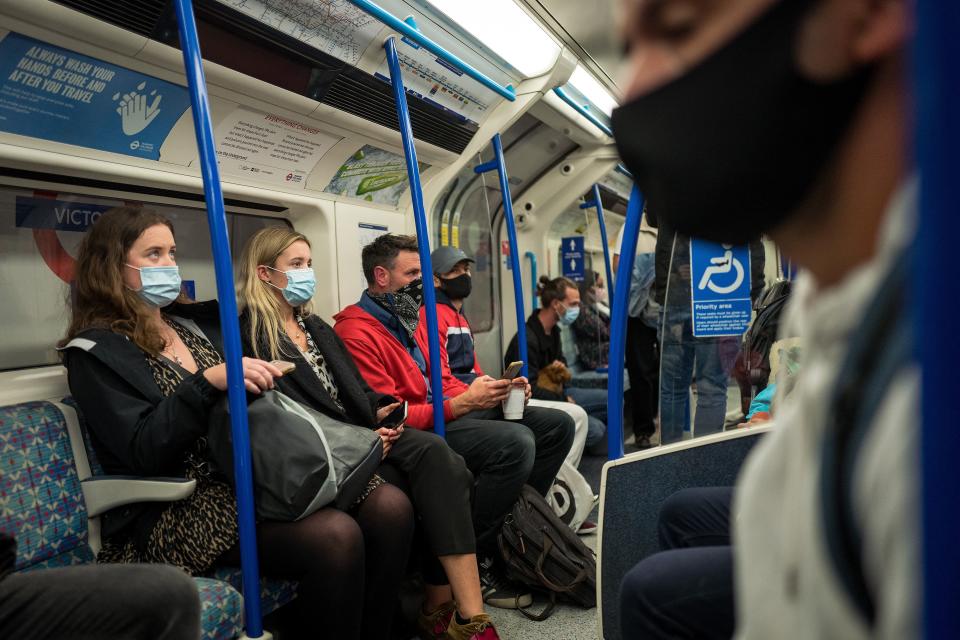 Commuters wearing face masks or covering due to the COVID-19 pandemic, sit aboard a Victoria Line London underground tube train as they travel during the evening 'rush hour' in central London on September 23, 2020. - The UK on Wednesday reported 6,178 new coronavirus cases, a marked jump in the daily infection rate that comes a day after Prime Minister Boris Johnson unveiled new nationwide restrictions. (Photo by Tolga AKMEN / AFP) (Photo by TOLGA AKMEN/AFP via Getty Images)