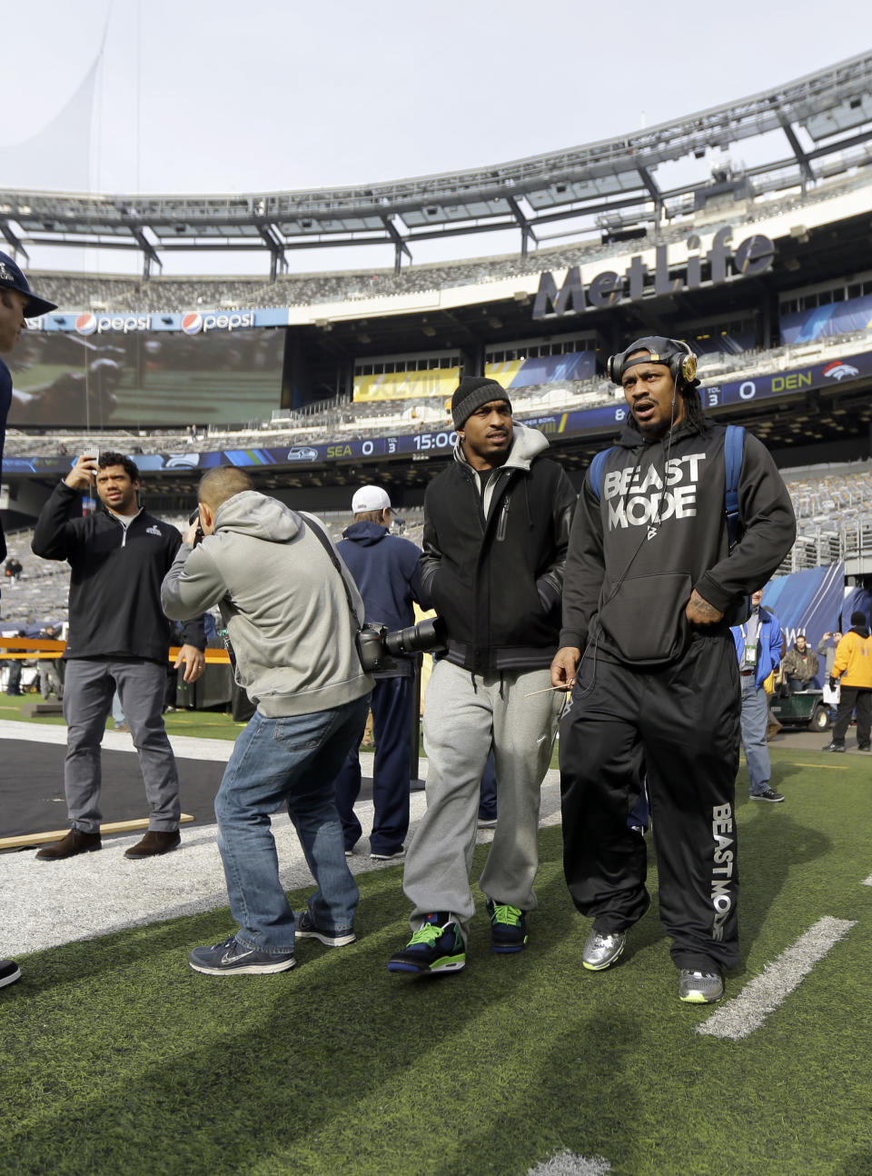 Seattle Seahawks quarterback Russell Wilson, left, and running back Marshawn Lynch, right, make a brief visit to MetLife Stadium along with other members of the team Saturday, Feb. 1, 2014, in East Rutherford, N.J. The Seahawks and the Denver Broncos are scheduled to play in the Super Bowl XLVIII football game Sunday, Feb. 2, 2014. (AP Photo/Jeff Roberson)