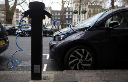 FILE PHOTO: Electric cars are plugged into a charging point in London, Britain, April 7, 2016. REUTERS/Neil Hall/File Photo
