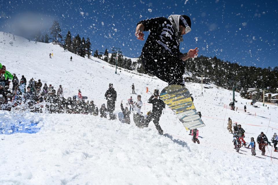 Darren Bailey, 38, of Torrance gets some air after crossing over the pond skim at the Bear Break event on Saturday, April 6, 2024 in Big Bear.