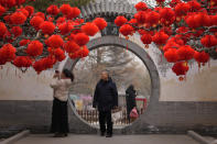 FILE - Residents take souvenir photo of a tree decorated with red lanterns ahead of the Chinese Lunar New Year at Ditan Park in Beijing, Sunday, Feb. 4, 2024. Chinese will celebrate Lunar New Year on Feb. 10 this year which marks the Year of the dragon on the Chinese zodiac. (AP Photo/Andy Wong, File)