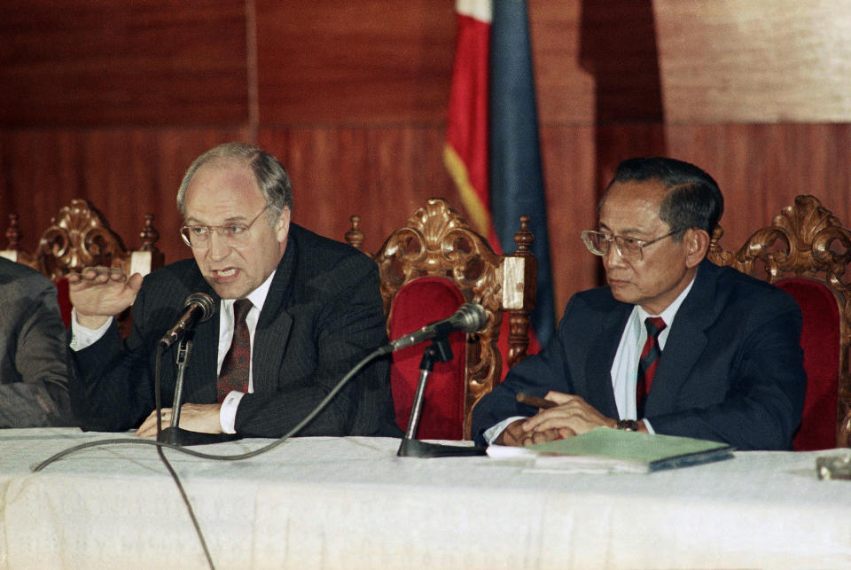 FILE - U.S. Defense Secretary Dick Cheney speaks during a joint news conference with his Philippine counterpart Fidel Ramos in the Philippines at the Armed Forces headquarters on Feb. 19, 1990. Ramos, a U.S.-trained ex-general who saw action in the Korean and Vietnam wars and played a key role in a 1986 pro-democracy uprising that ousted a dictator, has died. He was 94. Some of Ramos's relatives were with him when he died on Sunday, July 31, 2022, said his longtime aide Norman Legaspi. (AP Photo/Alberto Marquez, File)