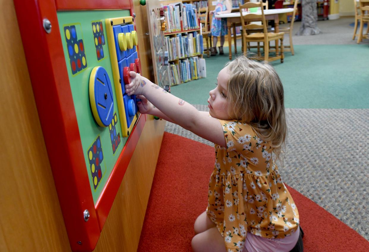 Lucy Boyd, 5, of Jackson Township, spends time playing on a rainy Monday, April 1, 2024, at Massillon Public Library.