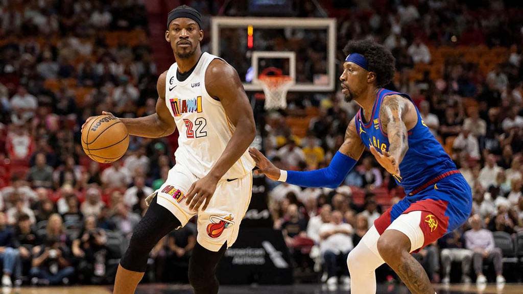  Miami Heat forward Jimmy Butler dribbles while Denver Nuggets guard Kentavious Caldwell-Pope defends during the first quarter of an NBA game at Kaseya Center on Monday, Feb. 13, 2023 