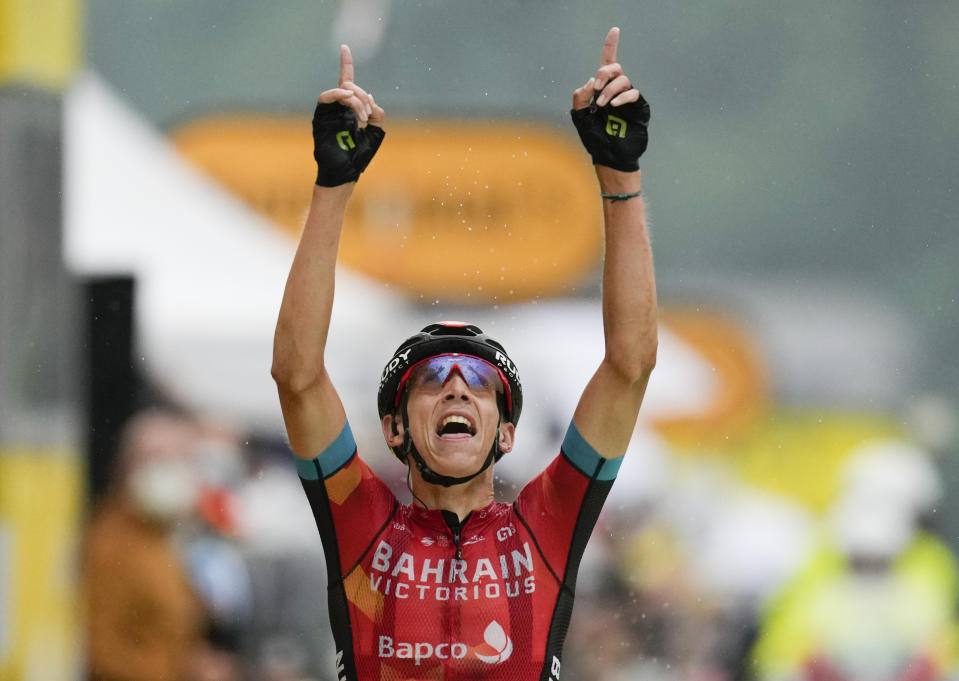 Belgium's Dylan Teuns celebrates as he crosses the finish line to win the eighth stage of the Tour de France cycling race over 150.8 kilometers (93.7 miles) with start in Oyonnax and finish in Le Grand-Bornand, France,Saturday, July 3, 2021. (AP Photo/Daniel Cole)