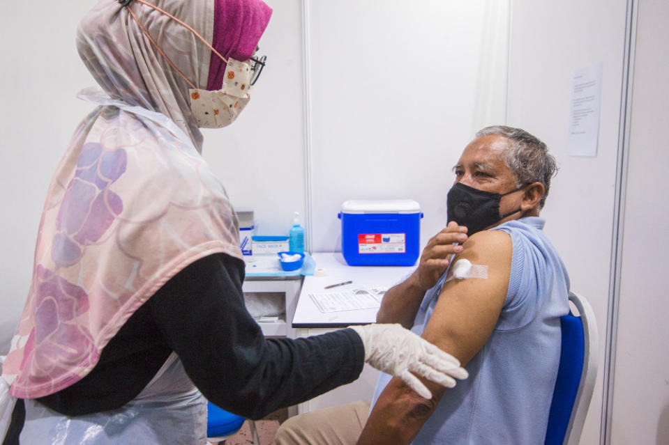 People receive their vaccine at the Covid-19 vaccination centre at the Mines International Exhibition and Convention Centre, Seri Kembangan, June 17, 2021. — Picture by Shafwan Zaidon