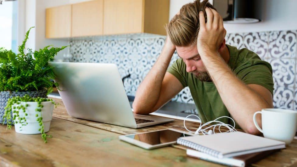 Man looking at laptop stressed