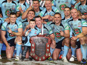 <p>The NSW Blues celebrate with the Origin shield.</p>