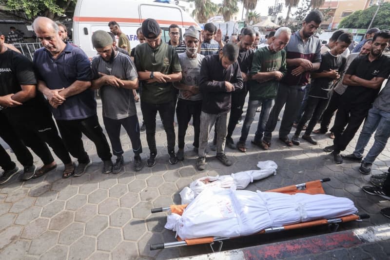 Palestinians perform funeral prayers for their relatives at the Aqsa Martyrs Hospital in Deir el-Balah who were killed in Israeli bombardments in the central Gaza Strip, amid the ongoing Israeli war in Gaza. Omar Ashtawy/APA Images via ZUMA Press Wire/dpa