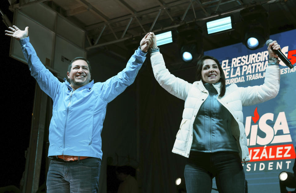 Presidential candidate Luisa González, of the Citizen's Revolution Political Movement, and her running mate Andres Arauz, celebrate after early results showed them ahead in a snap election, in Quito, Ecuador, Sunday, Aug. 20, 2023. The election was called after President Guillermo Lasso dissolved the National Assembly by decree in May to avoid being impeached. (AP Photo/Dolores Ochoa)