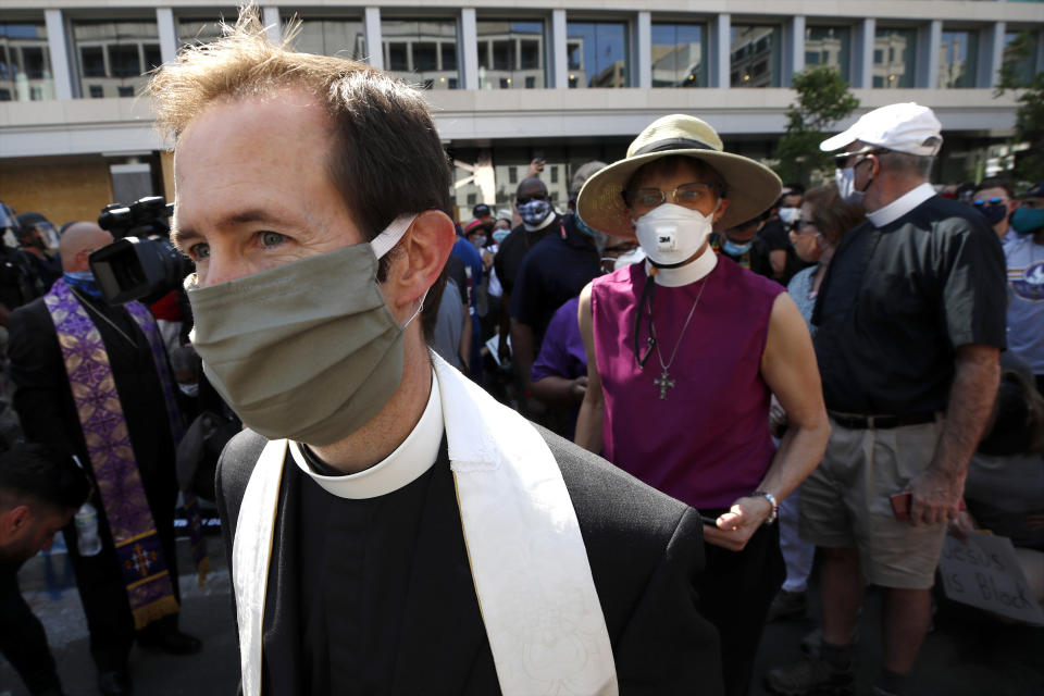 Rev. Robert Fisher, rector of St. John's Church, and The Rev. Mariann Budde, bishop of the Episcopal Diocese of Washington, right, depart after speaking Wednesday, June 3, 2020, down the block from the church that is across Lafayette Park from the White House in Washington. (AP Photo/Alex Brandon)