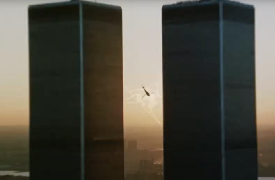 Helicopter flies between the Twin Towers of the World Trade Center during sunset