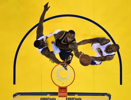 Jun 14, 2015; Oakland, CA, USA; Cleveland Cavaliers forward LeBron James (23) shoots the ball against Golden State Warriors forward Draymond Green (23) and guard Andre Iguodala (9) in game five of the NBA Finals at Oracle Arena. John G. Mabanglo-Pool Photo via USA TODAY Sports