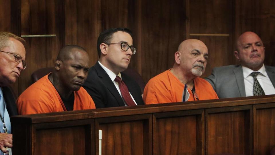 Flanked by their attorneys and the court interpreter, Alexis Vila-Perdomo, second from left, and Roberto Isaac listen during sentencing at Miami-Dade criminal court. The two men were convicted for their roles in the gruesome kidnapping and murder of Camilo Salazar. Prosecutors say he was murdered at the behest of a former owner of Presidente Supermarkets.