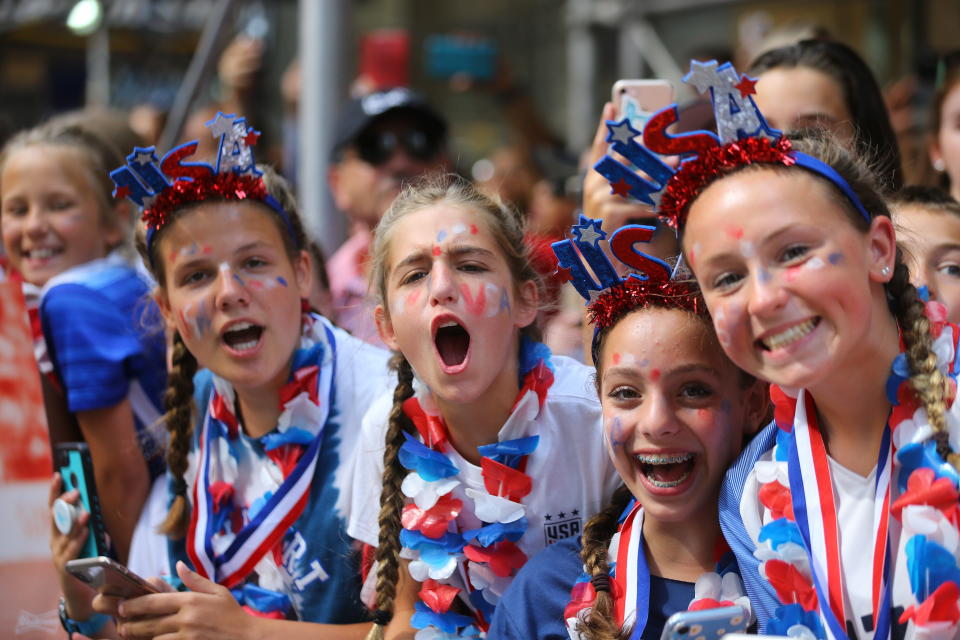 Fans celebrate as members of the U.S. women's soccer team pass by during a ticker tape parade along the Canyon of Heroes, Wednesday, July 10, 2019, in New York. (Photo: Gordon Donovan/Yahoo News)