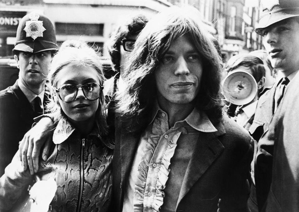 Mick Jagger of the Rolling Stones and girlfriend, singer Marianne Fiathfull, arrive at Magistrate's Court early May 29 to face charges of possessing marijuana. The couple, arrested during a police raid on Jagger's apartment May 28, was released an $120 bond.